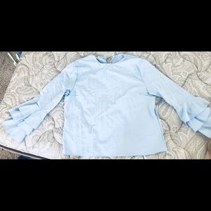A brand new bell sleeved ice blue top